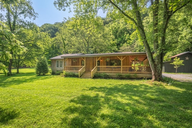 5191 Still House Hollow Rd, Franklin, TN 37064 - rustic home featuring a porch, a front lawn, and a forest view