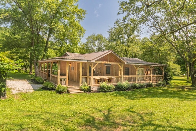 5191 Still House Hollow Rd, Franklin, TN 37064 - view of front facade featuring covered porch, a front yard, and a metal roof