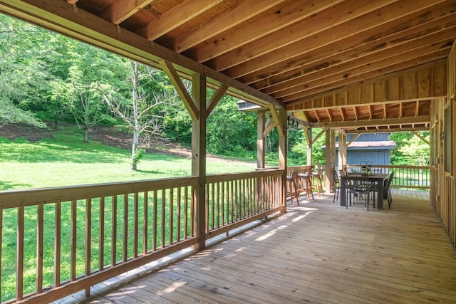 5191 Still House Hollow Rd, Franklin, TN 37064 - wooden deck featuring outdoor dining area, a lawn, and a storage unit
