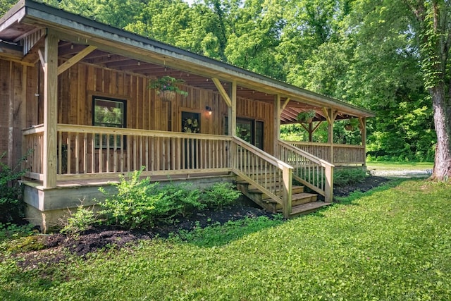 5191 Still House Hollow Rd, Franklin, TN 37064 - view of front of property with covered porch, board and batten siding, a front yard, and a forest view
