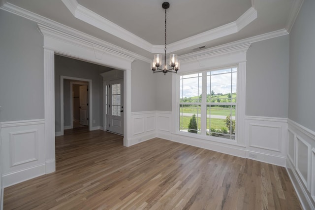 135 Bruce Meadows Dr, Beechgrove, TN 37018 - unfurnished dining area featuring a chandelier, light wood-style floors, a decorative wall, a wainscoted wall, and crown molding