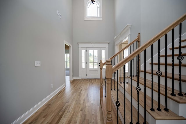 135 Bruce Meadows Dr, Beechgrove, TN 37018 - foyer entrance featuring healthy amount of natural light, wood finished floors, a towering ceiling, and stairs