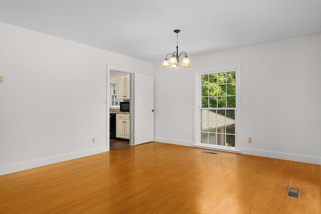 2411 Woolson Rd, Chattanooga, TN 37406 - unfurnished room featuring a chandelier and wood finished floors