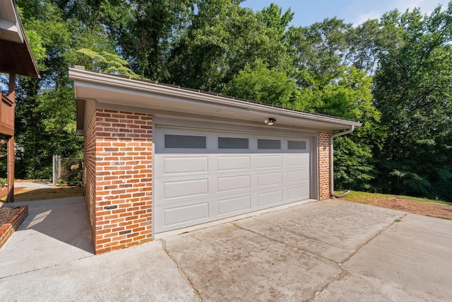 2411 Woolson Rd, Chattanooga, TN 37406 - garage featuring concrete driveway and view of wooded area