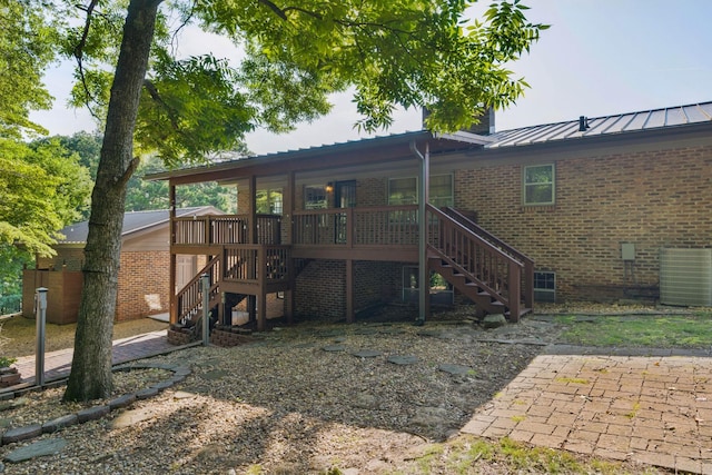 2411 Woolson Rd, Chattanooga, TN 37406 - back of house featuring stairway, brick siding, a standing seam roof, and a metal roof