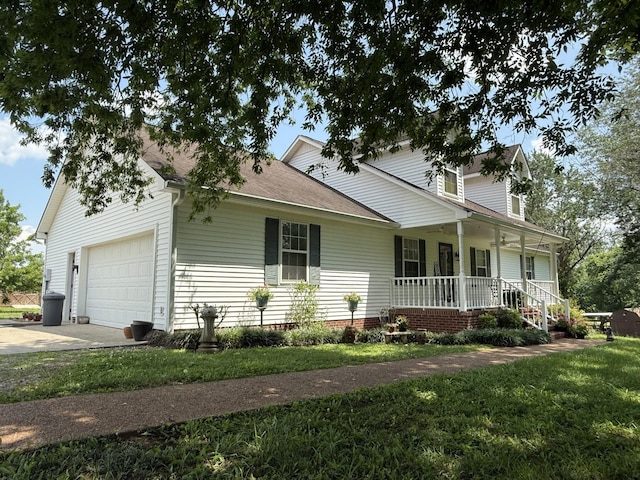 3330 Booker Farm Rd, Mount Pleasant, TN 38474 - view of front of house with covered porch, concrete driveway, a front yard, an attached garage, and a shingled roof