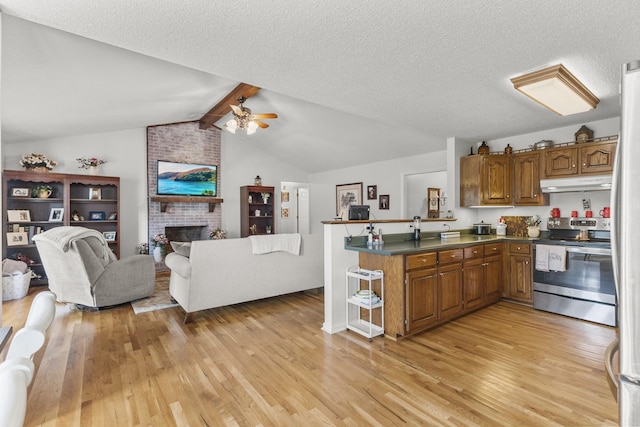 3330 Booker Farm Rd, Mount Pleasant, TN 38474 - kitchen with electric stove, under cabinet range hood, brown cabinetry, a peninsula, and open floor plan