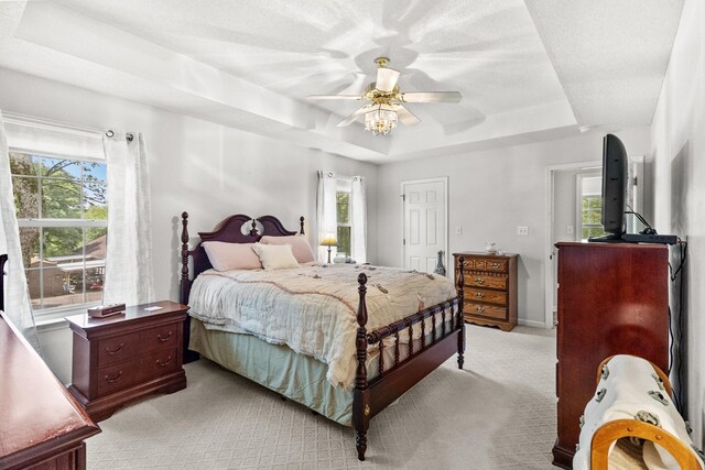 3330 Booker Farm Rd, Mount Pleasant, TN 38474 - bedroom featuring a raised ceiling, light colored carpet, multiple windows, and a ceiling fan
