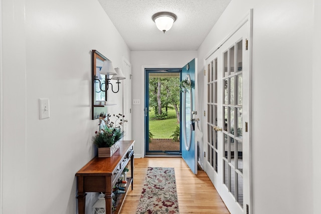 3330 Booker Farm Rd, Mount Pleasant, TN 38474 - doorway featuring a textured ceiling, light wood finished floors, and french doors