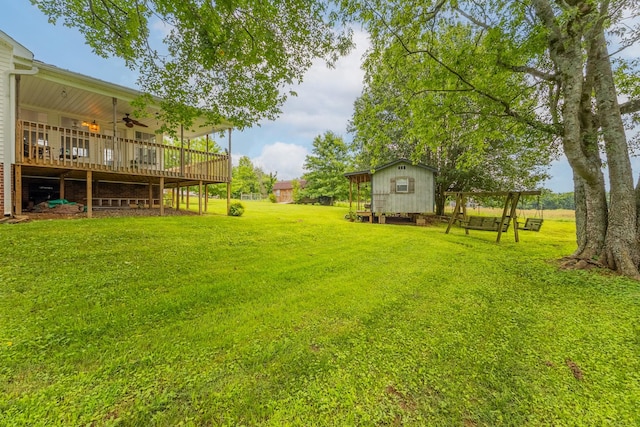 3330 Booker Farm Rd, Mount Pleasant, TN 38474 - view of grassy yard featuring a ceiling fan, an outbuilding, and a wooden deck