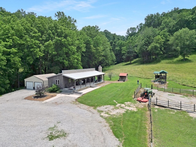 189 Cross Creek Dr, Manchester, TN 37355 - view of front of house with an outbuilding, a chimney, a garage, and a forest view