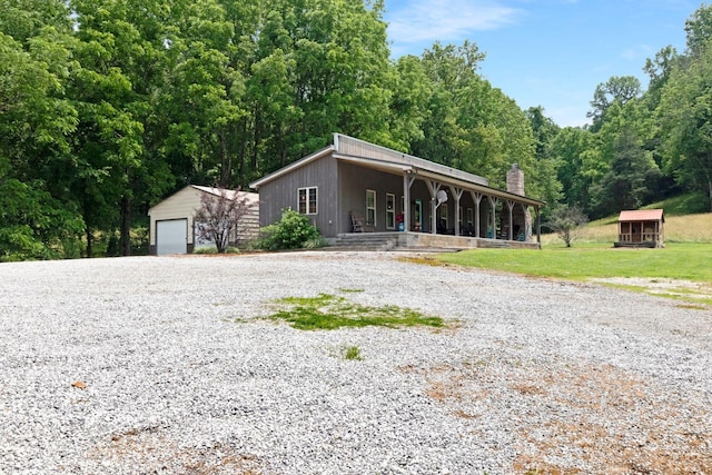 189 Cross Creek Dr, Manchester, TN 37355 - view of front of home featuring a porch, an outbuilding, a garage, driveway, and a chimney