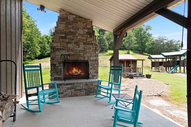 189 Cross Creek Dr, Manchester, TN 37355 - view of patio / terrace with an outdoor stone fireplace, a playground, and view of wooded area