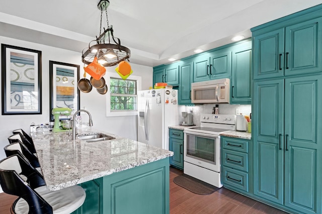 189 Cross Creek Dr, Manchester, TN 37355 - kitchen featuring white appliances, a breakfast bar area, dark wood-type flooring, light stone counters, and vaulted ceiling