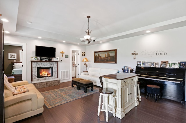 189 Cross Creek Dr, Manchester, TN 37355 - living area featuring a raised ceiling, dark wood-style floors, a chandelier, recessed lighting, and a warm lit fireplace