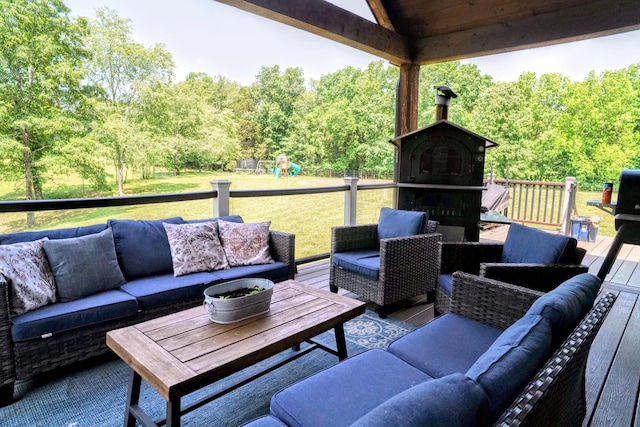 450 Lowe Branch Rd, Centerville, TN 37033 - view of patio featuring an outdoor living space with a fireplace, a wooded view, a wooden deck, and a playground