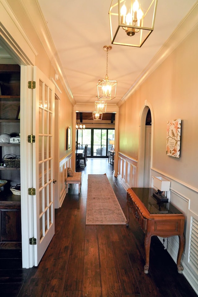 450 Lowe Branch Rd, Centerville, TN 37033 - corridor featuring a chandelier, ornamental molding, a decorative wall, dark wood finished floors, and wainscoting