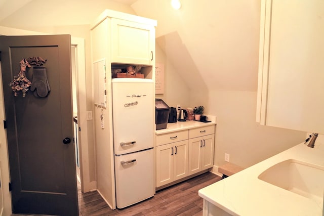 450 Lowe Branch Rd, Centerville, TN 37033 - kitchen with freestanding refrigerator, dark wood-style floors, lofted ceiling, light countertops, and white cabinetry