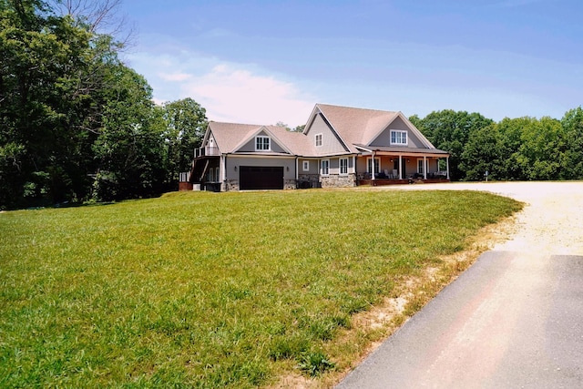 450 Lowe Branch Rd, Centerville, TN 37033 - view of front of house with stone siding, covered porch, a front yard, driveway, and a garage