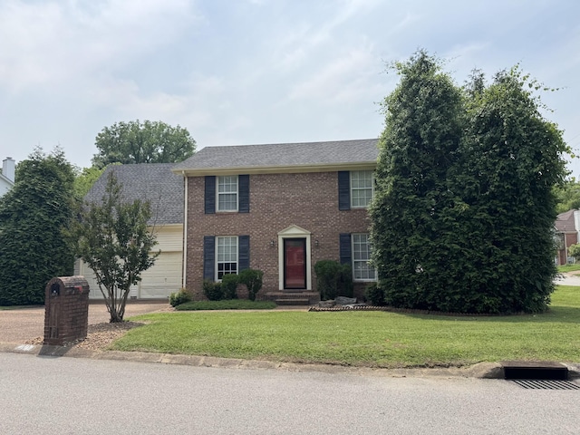 1200 Springwood Dr, Old Hickory, TN 37138 - colonial-style house with brick siding, a front yard, an attached garage, and a shingled roof