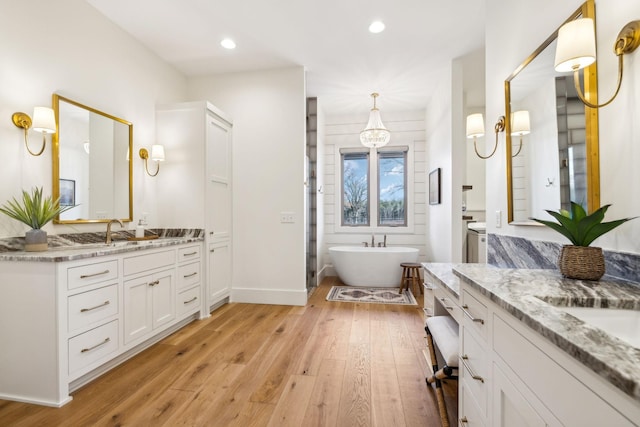 1249 Wilson School Rd, Chapel Hill, TN 37034 - full bath with wood finished floors, two vanities, a freestanding tub, and recessed lighting