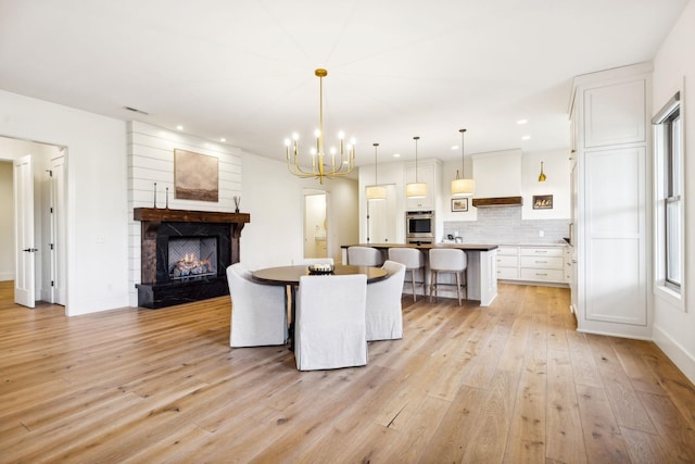 1249 Wilson School Rd, Chapel Hill, TN 37034 - dining area with light wood-style flooring, a chandelier, a lit fireplace, and recessed lighting