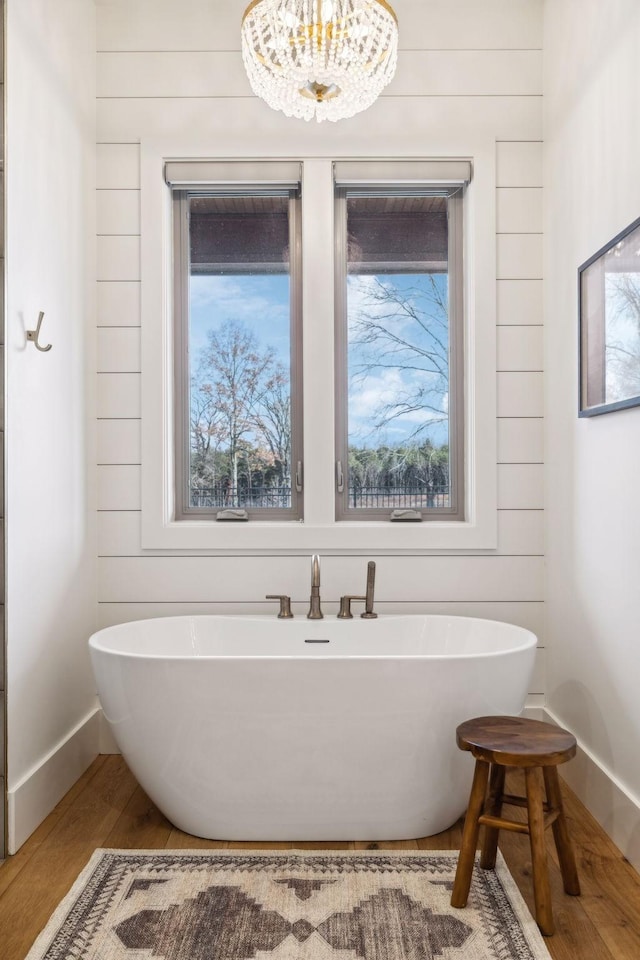 1249 Wilson School Rd, Chapel Hill, TN 37034 - bathroom featuring a freestanding tub, wood finished floors, and a chandelier