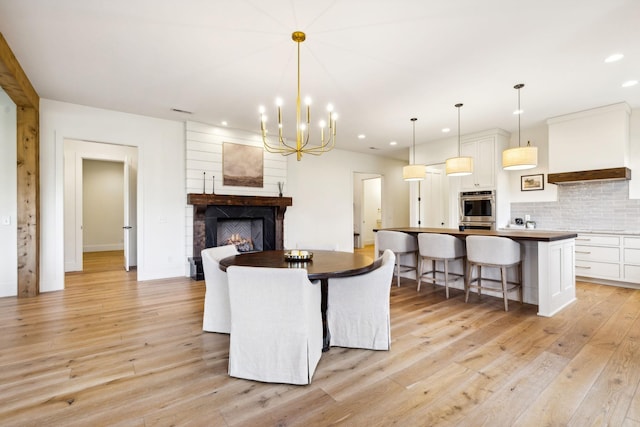 1249 Wilson School Rd, Chapel Hill, TN 37034 - dining room with recessed lighting, light wood-style flooring, a chandelier, and a warm lit fireplace
