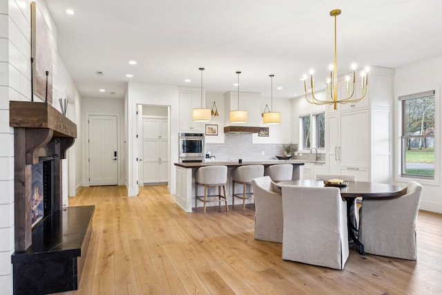 1249 Wilson School Rd, Chapel Hill, TN 37034 - dining room with healthy amount of natural light, a large fireplace, light wood-style floors, recessed lighting, and a chandelier