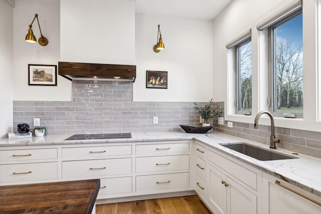 1249 Wilson School Rd, Chapel Hill, TN 37034 - kitchen featuring white cabinetry, light stone countertops, backsplash, and black electric cooktop
