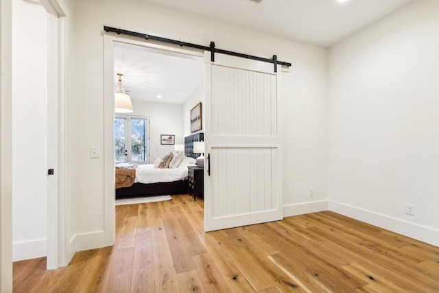 1249 Wilson School Rd, Chapel Hill, TN 37034 - bedroom with light wood-style flooring and a barn door