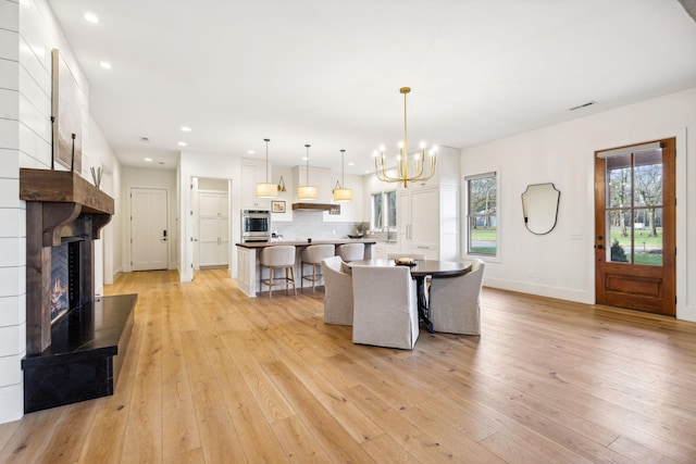 1249 Wilson School Rd, Chapel Hill, TN 37034 - dining space with recessed lighting, a chandelier, light wood-style flooring, and a large fireplace