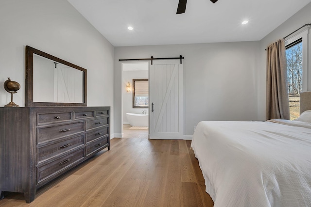 673 Billy Wynn Rd, Dickson, TN 37055 - bedroom featuring a barn door, light wood-type flooring, recessed lighting, ensuite bath, and a ceiling fan
