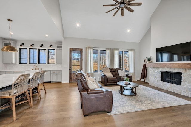 673 Billy Wynn Rd, Dickson, TN 37055 - living area featuring high vaulted ceiling, ceiling fan, recessed lighting, a stone fireplace, and healthy amount of natural light
