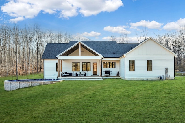673 Billy Wynn Rd, Dickson, TN 37055 - rear view of house with board and batten siding, an outdoor pool, and a yard