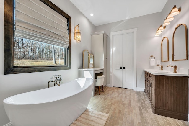 673 Billy Wynn Rd, Dickson, TN 37055 - full bathroom featuring vanity, a soaking tub, wood finished floors, and recessed lighting