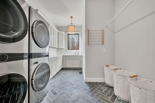 673 Billy Wynn Rd, Dickson, TN 37055 - laundry area featuring stacked washer / drying machine and cabinet space