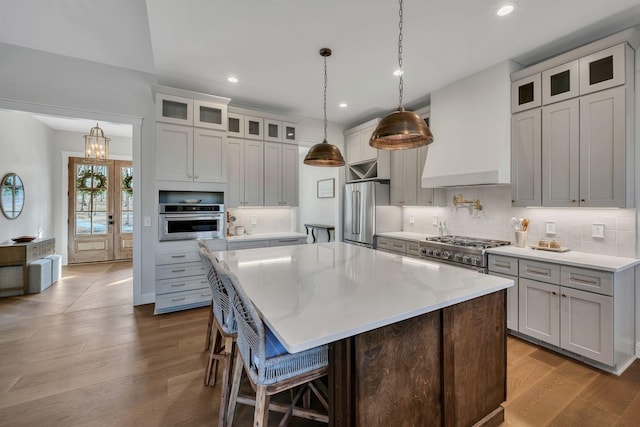 673 Billy Wynn Rd, Dickson, TN 37055 - kitchen with stainless steel appliances, recessed lighting, tasteful backsplash, a kitchen island, and wood finished floors