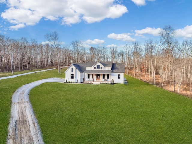 673 Billy Wynn Rd, Dickson, TN 37055 - modern farmhouse style home featuring covered porch, a front lawn, driveway, and board and batten siding