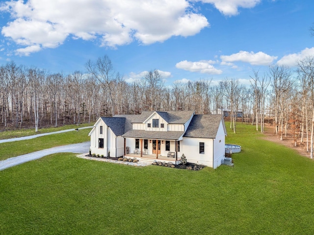 673 Billy Wynn Rd, Dickson, TN 37055 - modern farmhouse style home featuring covered porch, a front yard, board and batten siding, driveway, and roof with shingles