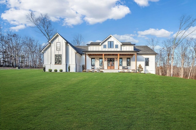 673 Billy Wynn Rd, Dickson, TN 37055 - view of front of home featuring board and batten siding, covered porch, a front lawn, and roof with shingles