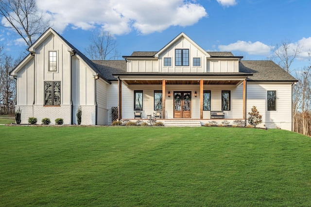 673 Billy Wynn Rd, Dickson, TN 37055 - view of front of home featuring board and batten siding, covered porch, a front lawn, and a shingled roof