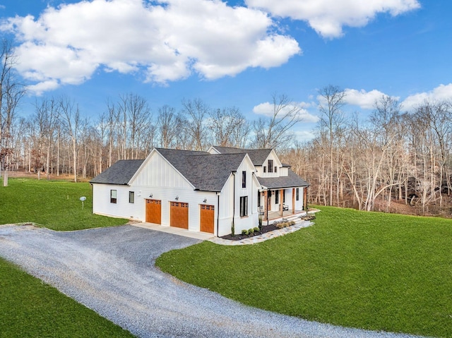 673 Billy Wynn Rd, Dickson, TN 37055 - view of front of home with gravel driveway, covered porch, board and batten siding, a front lawn, and roof with shingles