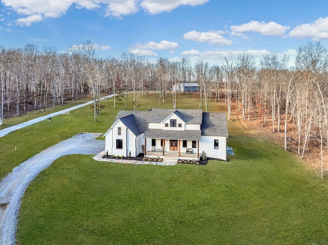 673 Billy Wynn Rd, Dickson, TN 37055 - modern farmhouse style home with covered porch, a front yard, driveway, and a shingled roof