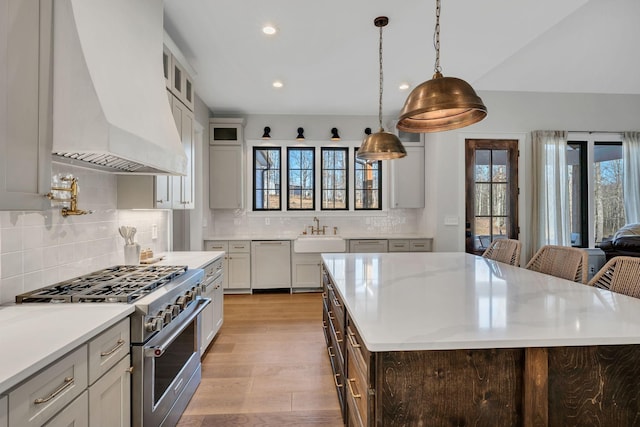 673 Billy Wynn Rd, Dickson, TN 37055 - kitchen with stainless steel range, custom exhaust hood, light wood finished floors, tasteful backsplash, and recessed lighting