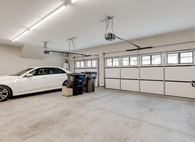 1036 Wilderness Way, Cottontown, TN 37048 - garage featuring a garage door opener and water heater