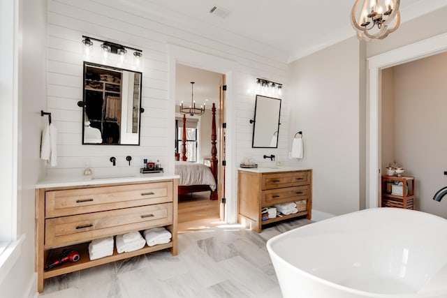 1036 Wilderness Way, Cottontown, TN 37048 - ensuite bathroom featuring a chandelier, vanity, and a freestanding bath