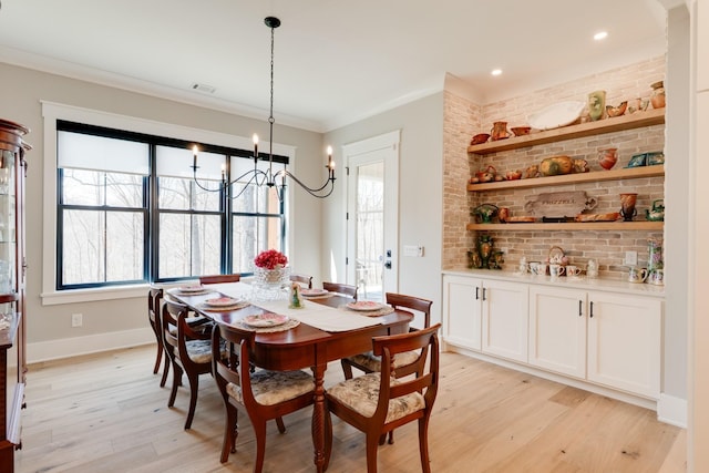 1036 Wilderness Way, Cottontown, TN 37048 - dining room with light wood-type flooring, plenty of natural light, crown molding, a chandelier, and brick wall