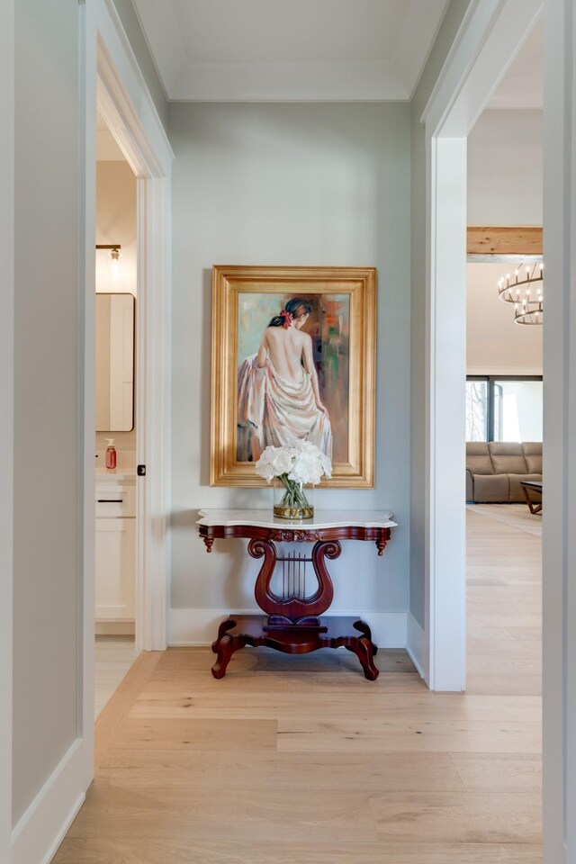 1036 Wilderness Way, Cottontown, TN 37048 - hallway with wood finished floors, a chandelier, and ornamental molding