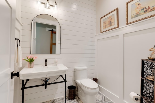 1036 Wilderness Way, Cottontown, TN 37048 - half bathroom with wood walls and tile patterned flooring